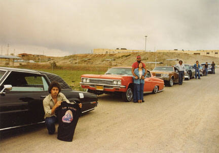 Sammy Martinez and Los Unidos - Franke Maestas and Vangie Martinez, Leroy Martinez, Rob Garcia, Delfino Martinez, and Donaldo Valdez-Espanola, '68 T-Bird, '66 Chevy Caprice, '70 Supersport, '56 Chevy, '62 Chevy, '49 Chevy, , from the "Lowriders: Portraits from New Mexico" portfolio