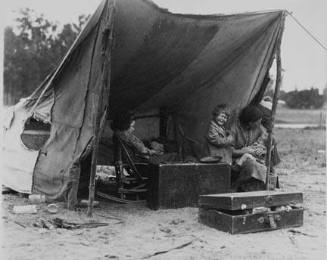 Migrant agricultural worker's family. Seven children without food. Mother aged thirty-two. Father is a native Californian. Destitute in a pea pickers camp because of the failure of the early pea crop. These people had just sold their tires in order to buy food. Most of the 2,500 people in this camp were destitute. Nipomo, California