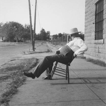 The sheriff of McAlester, Oklahoma, sitting in front of the jail. He has been sheriff for thirty years