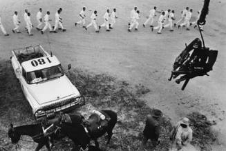 Guns are passed to the picket tower; the line returns from work, from the portfolio "Danny Lyon"