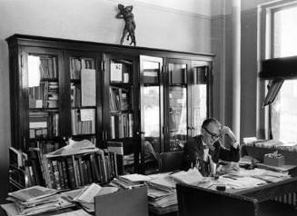 Untitled (man at desk with papers)