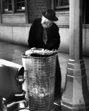 Park Avenue, New York (man reading newspaper over garbage bin)