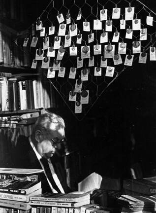 Untitled (man in store window reading)