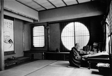 Kyoto, Japan (man seated reading by circular window)