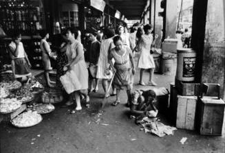 Manila (woman reading in rubbish pile)