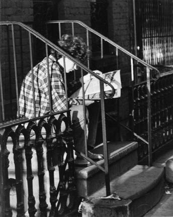 Untitled (young man reading on stoop)