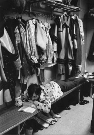 Circus, New York (performer lying on bench reading)