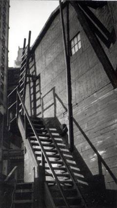 Untitled (side view of building and wooden fire escape, New York)