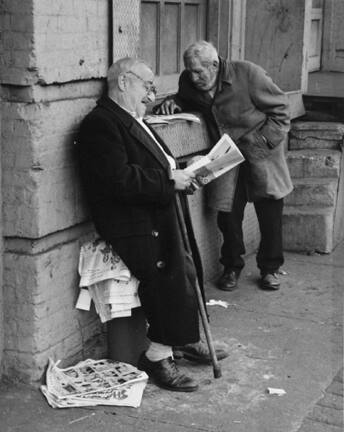 The Bowery, New York (two men reading newspapers)