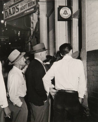 Untitled (crowd of men on sidewalk)