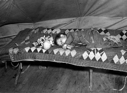 A child flood refugee taking a nap. Tent City near Shawneetown, Illinois