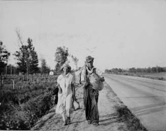 "Damned if we'll work for what they pay folks hereabouts." Crittenden County, Arkansas. Cotton workers on the road, carrying all they possess in the world