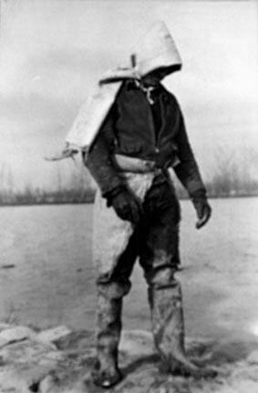 Levee worker during the flood, on a raw day with a thirty-mile wind. These men are very cold and almost exhausted from constant work