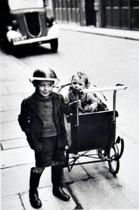 Life during the Blitz of World War II. A young boy wears his tin helmet with pride, London, England, from the "Magnum Founders: In Celebration of 60 Years" portfolio