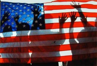 Children Playing Behind an American Flag Hanging in Little Village