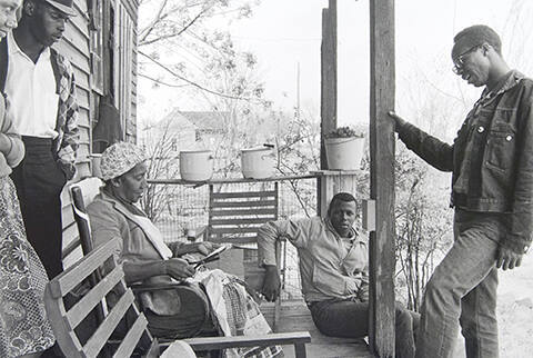 Charles Sherrod (standing at right) and Randy Battle (seated) visit a supporter in the Georgia countryside. Sherrod married there and thirty years later is still in southwest Georgia, a member of the Albany City Council.