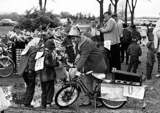 A hands-on Mom, Florence, at the time of the U-2 fiasco during the President Ike regime, readies a spy bike for Steven on which she’d secured an old Kodak view camera.