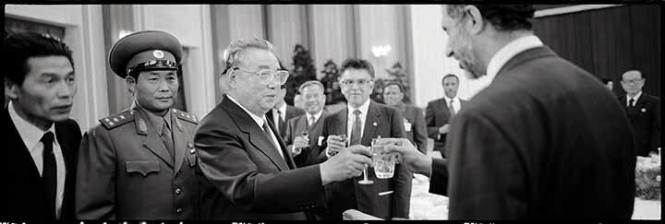 Kim Il Sung, President of the Democratic People's Republic of Korea, surrounded by bodyguards, drinks a glass of rice wine with a high personality of the Chinese government at a reception in the presidential palace on the occasion of his 80th birthday, April 15, 1992