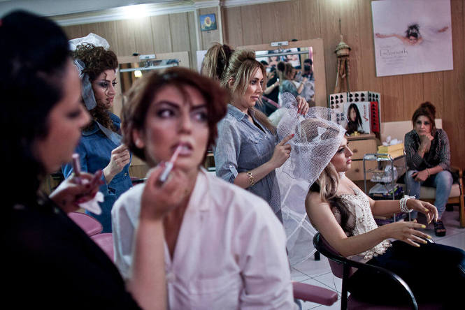 Tehran, Iran. Women being made up in a beauty salon where it is illegal for men to enter, as it is for men to do a woman's makeup.