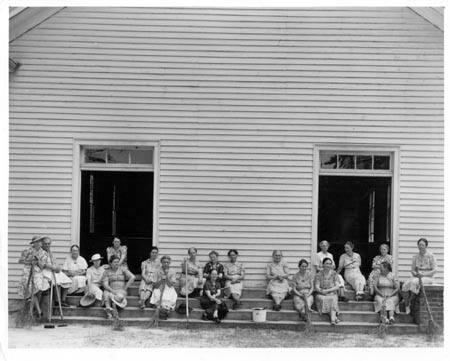 Women of the congregation of Wheeley's Church on steps with brooms and buckets on annual clean up day. Gordonton, North Carolina