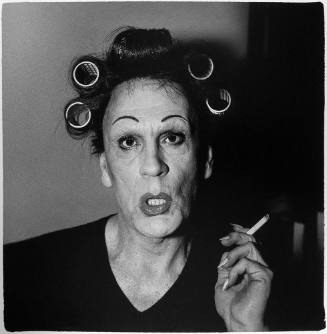 Diane Arbus / A Young man in curlers at home on West 20th Street, NYC (1966)