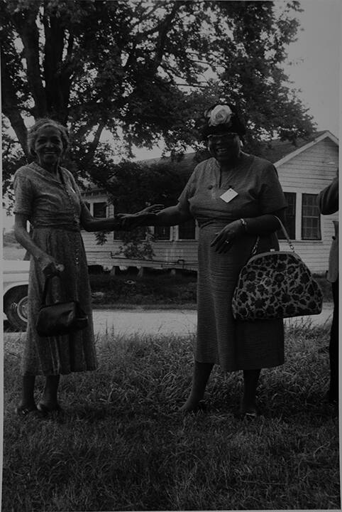 Mt. Bayou, MS. Two elderly women holding hands.