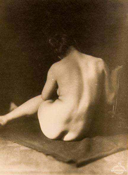 Untitled #55 (back view of seated female nude on dark blanket)