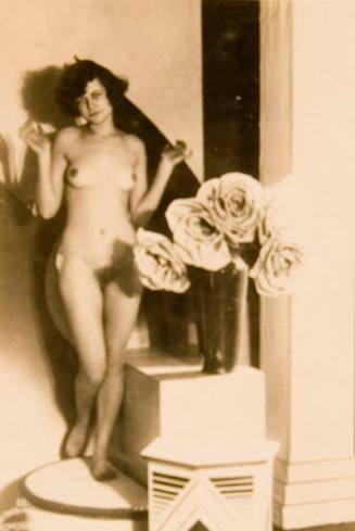 Untitled #85 (nude woman on pedestal, vase with large flowers)