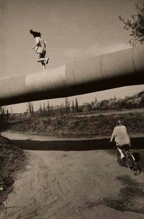 Untitled (Two youths: one walking on pipeline, one riding bike), from the "Ostrava" series