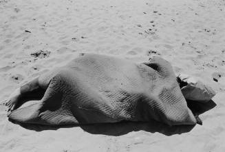 figure wrapped in blanket