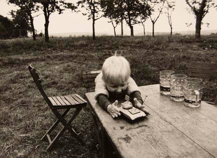 Untitled (child playing with toy tank), from the "Village Photo" series