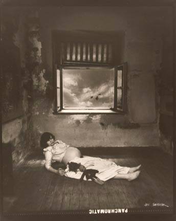 Untitled (pregnant woman lying on floor with doll)