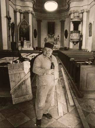 Untitled (worker in church with bottle), from the "Village Photo" series