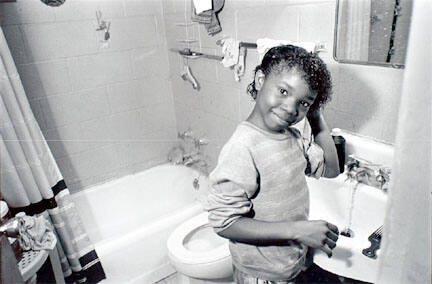 Young girl washing hair in sink, Cabrini-Green, from Changing Chicago