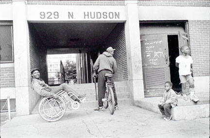 Outside 929 N Hudson, man with wheelchair, Cabrini-Green, from Changing Chicago